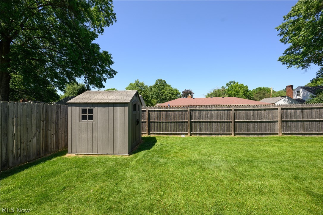 1243 Garman Road Akron, OH 44313 - Photo 7 of 21 View of yard featuring a storage unit