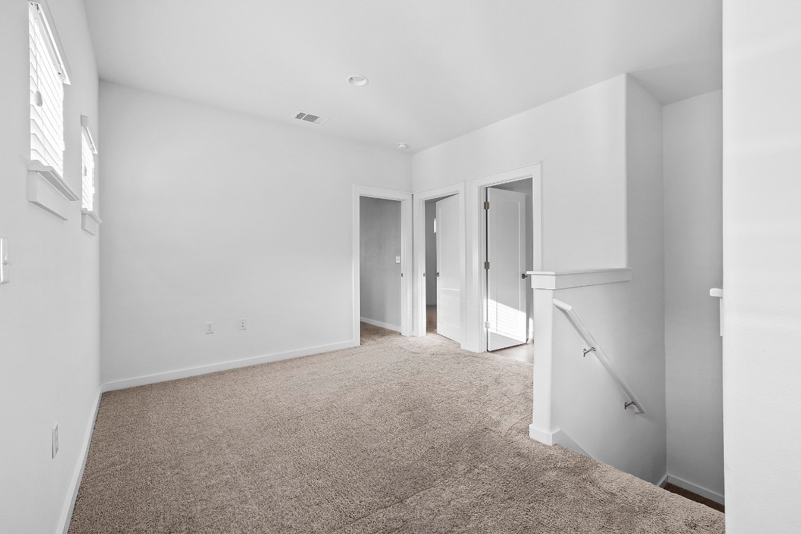 6800 Menchaca Road, Unit 22 Austin, TX 78745 - Photo 9 of 28 Empty room with carpet flooring and baseboards