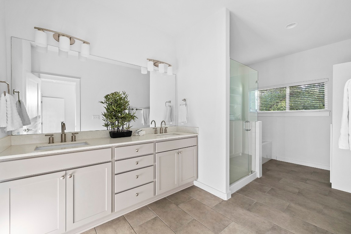 6800 Menchaca Road, Unit 22 Austin, TX 78745 - Photo 13 of 28 Bathroom with double vanity and a stall shower