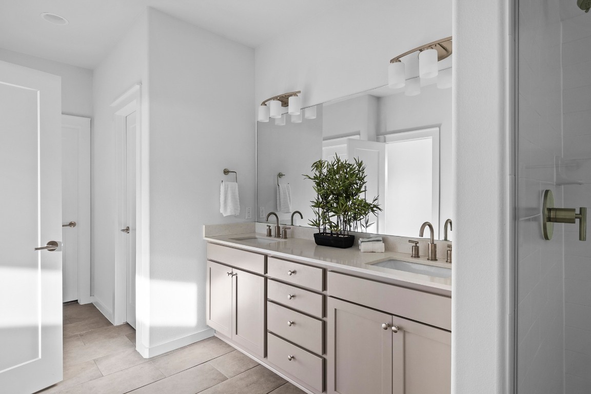 6800 Menchaca Road, Unit 22 Austin, TX 78745 - Photo 14 of 28 Bathroom with double vanity and a shower stall