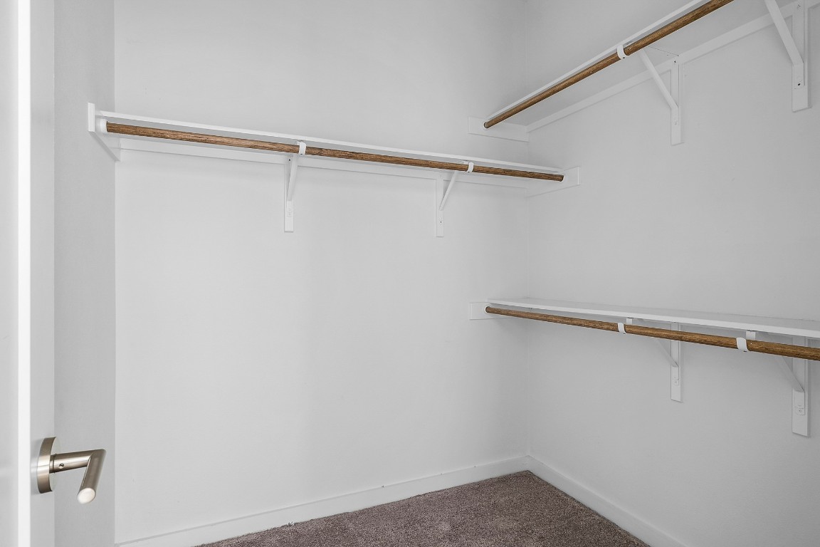 6800 Menchaca Road, Unit 22 Austin, TX 78745 - Photo 16 of 28 Walk in closet featuring dark carpet