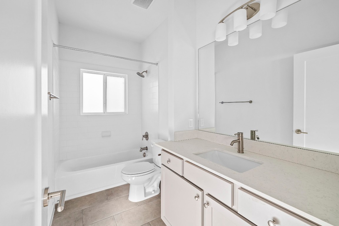 6800 Menchaca Road, Unit 22 Austin, TX 78745 - Photo 19 of 28 Full bathroom featuring shower / tub combination, vanity, and light tile patterned floors