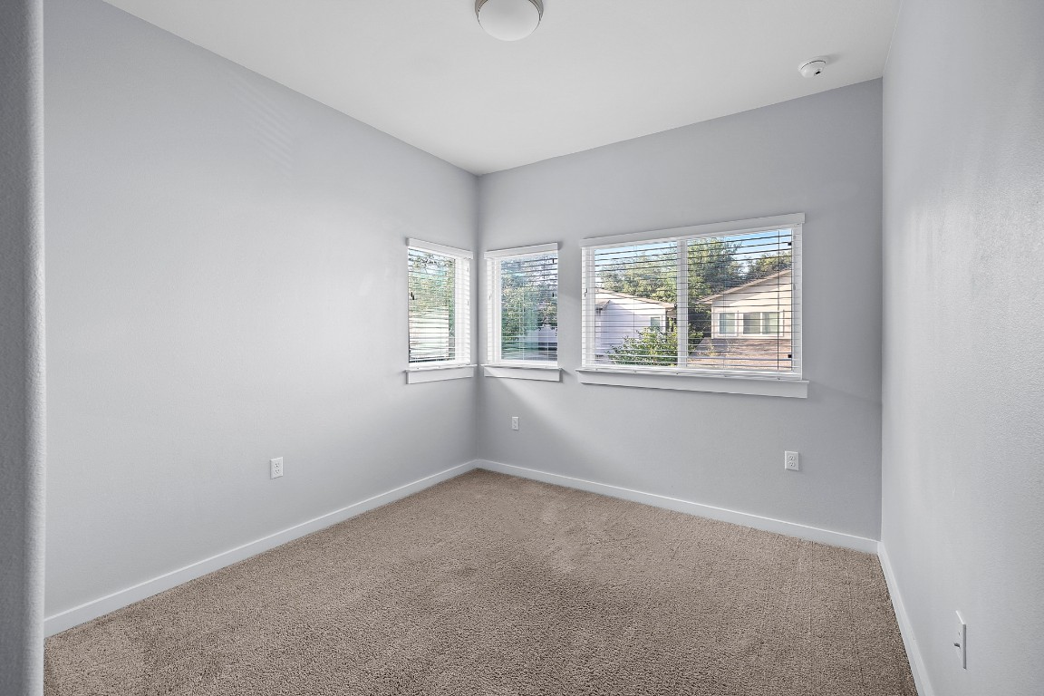 6800 Menchaca Road, Unit 22 Austin, TX 78745 - Photo 20 of 28 Carpeted empty room with plenty of natural light