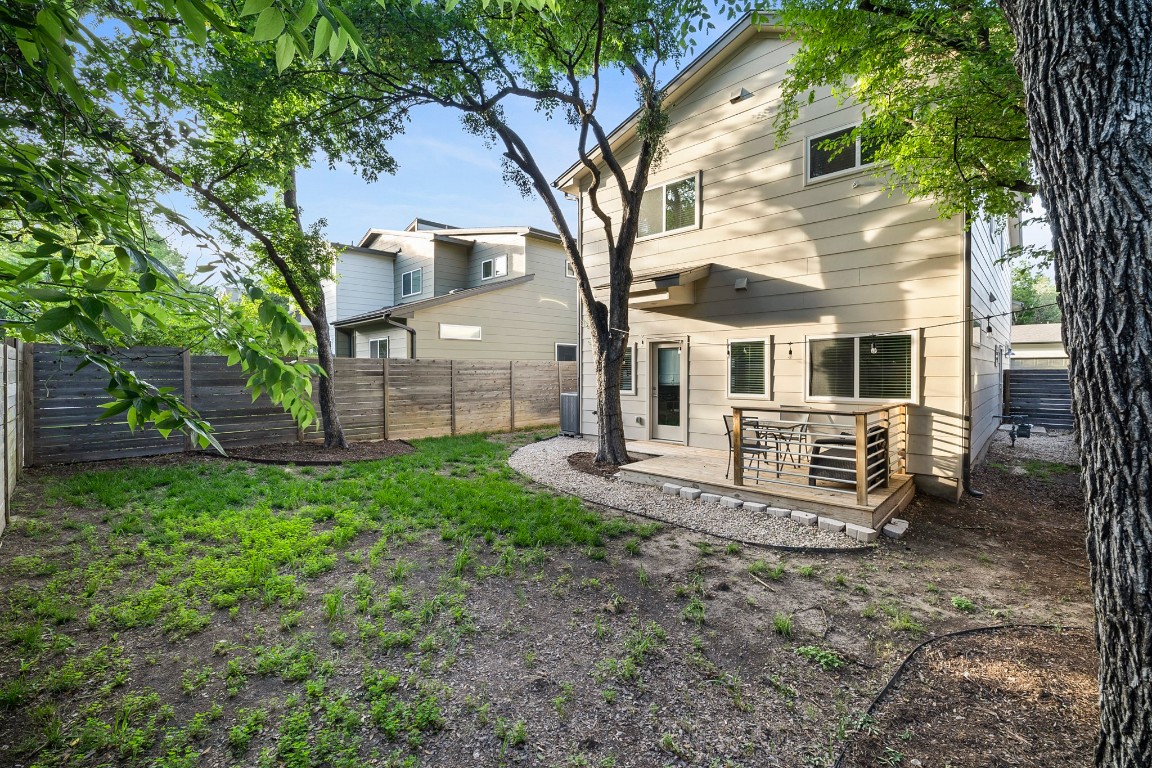 6800 Menchaca Road, Unit 22 Austin, TX 78745 - Photo 24 of 28 Back of property featuring a fenced backyard and a deck