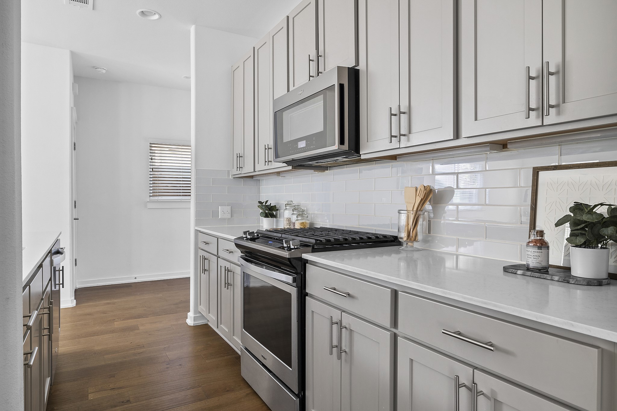 6800 Menchaca Road, Unit 22 Austin, TX 78745 - Photo 5 of 27 a kitchen with stainless steel appliances granite countertop white cabinets sink and stove