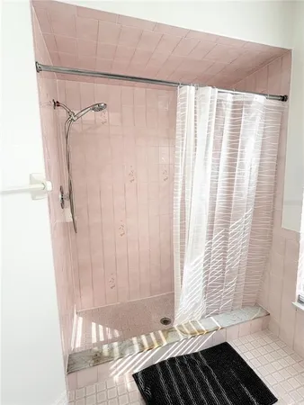 a bathroom with a bathtub and shower