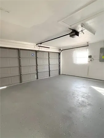 a living room with a floor to ceiling window and a table