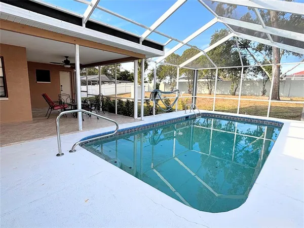 a view of a swimming pool with a lounge chairs