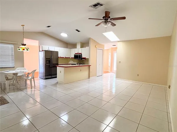 a large kitchen with cabinets and stainless steel appliances