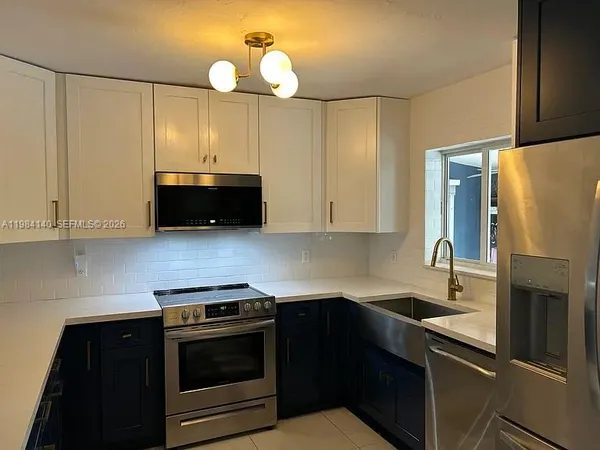 a kitchen with granite countertop a stove and a sink