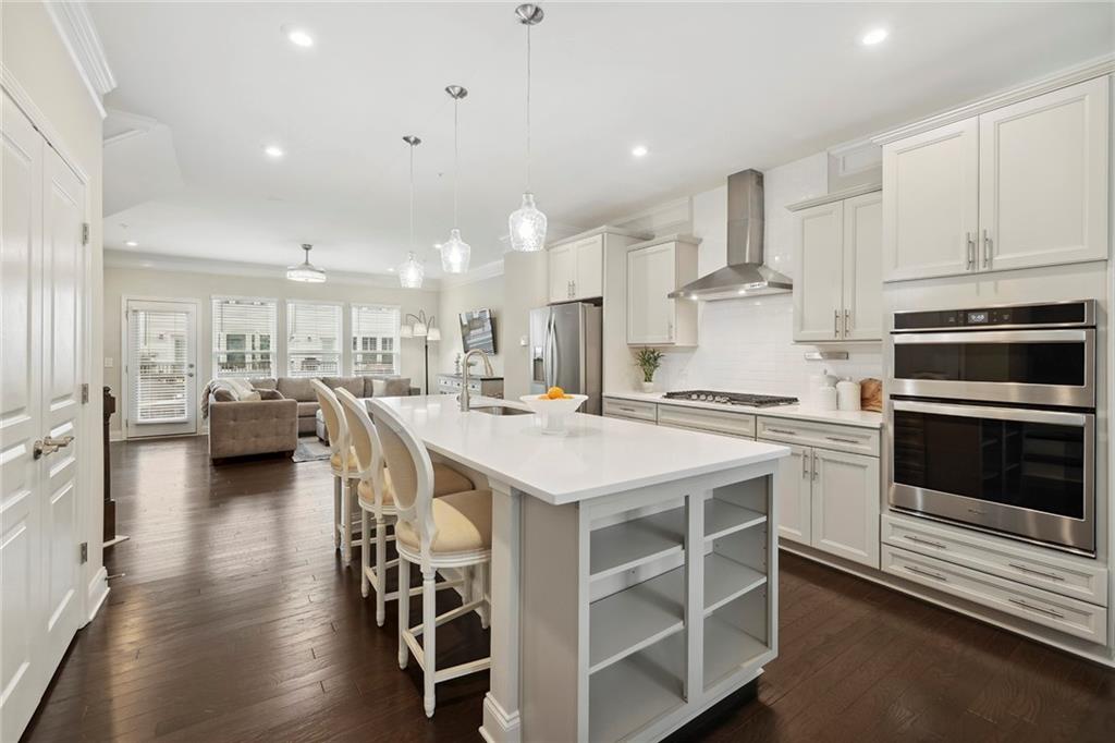 a kitchen with a sink stainless steel appliances and cabinets