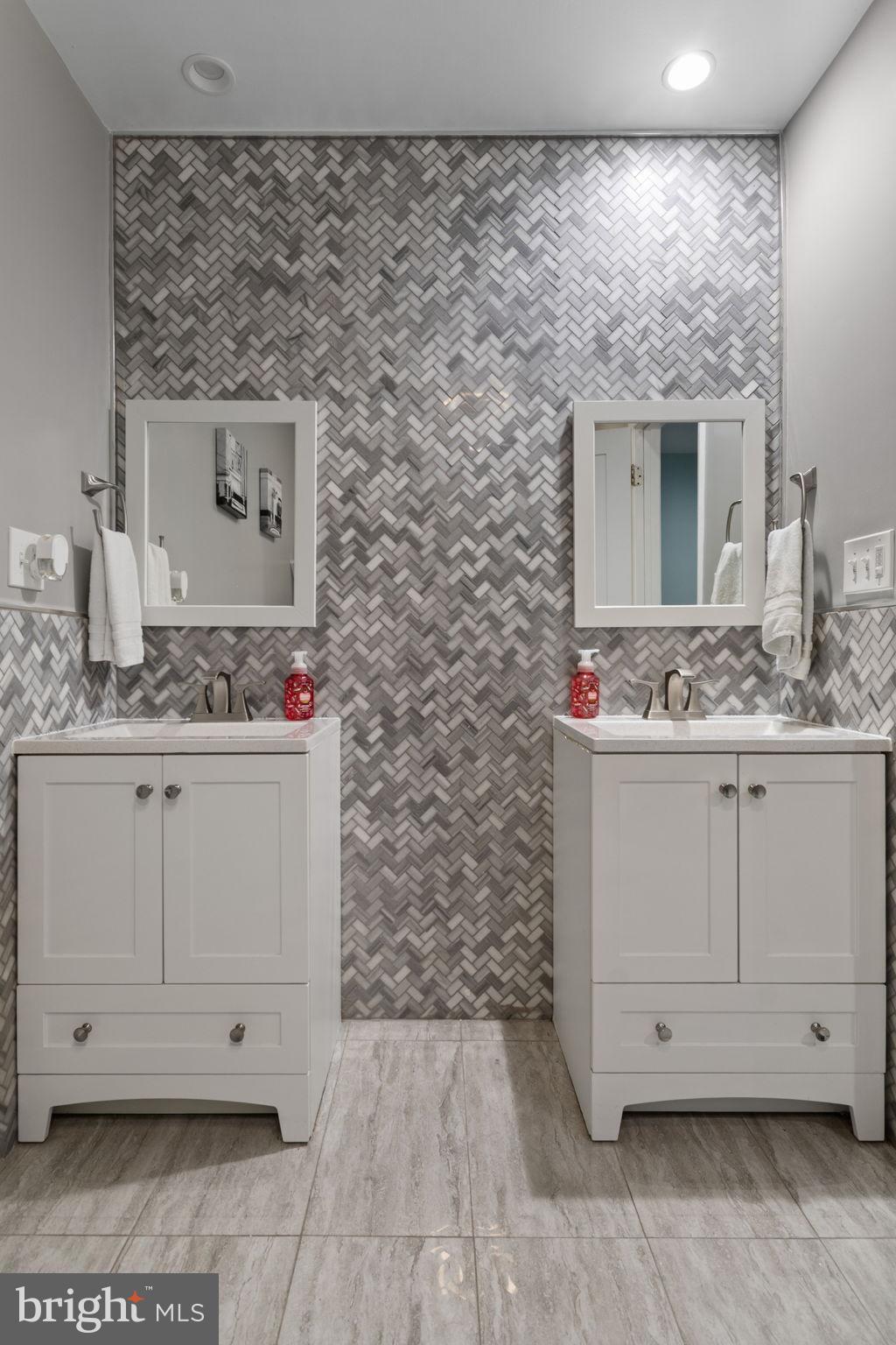 608 Blue Ridge Avenue Northeast Leesburg, VA 20176 - Photo 22 of 38 Elegant dual vanity in modern bathroom design.