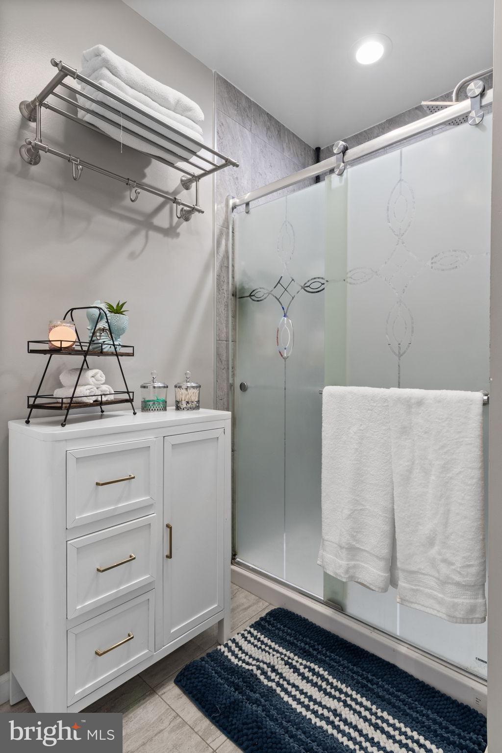 608 Blue Ridge Avenue Northeast Leesburg, VA 20176 - Photo 23 of 38 Modern bathroom with sleek glass shower.