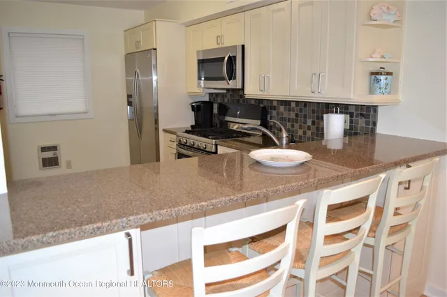 a kitchen with stainless steel appliances white cabinets and a stove