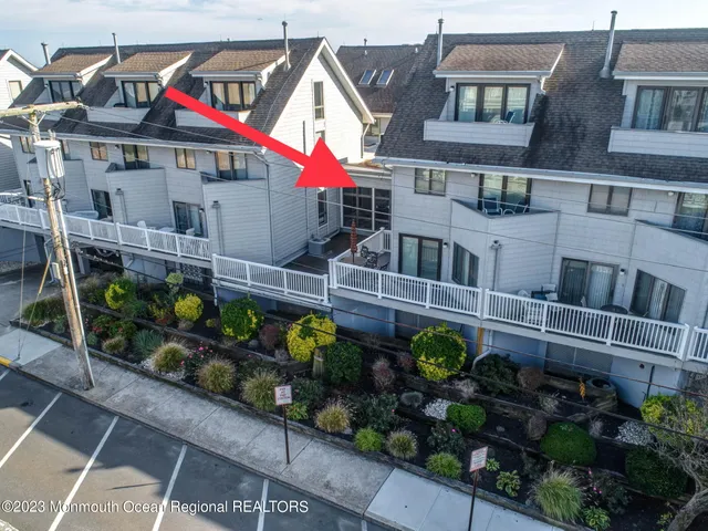 a living room with furniture a rug and a floor to ceiling window