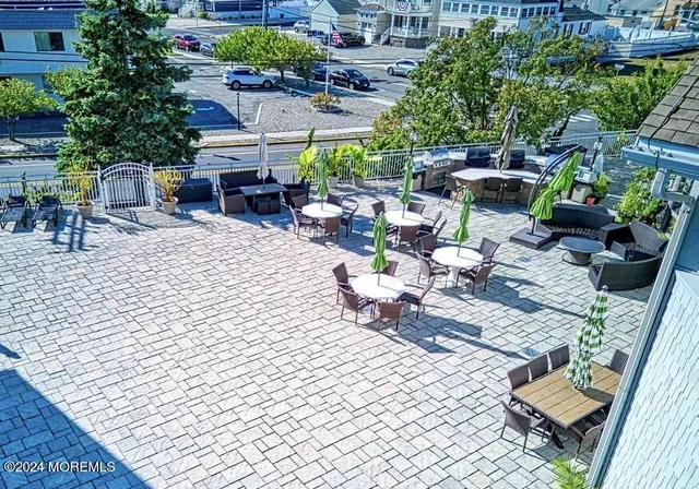 a view of a balcony with chairs and potted plants
