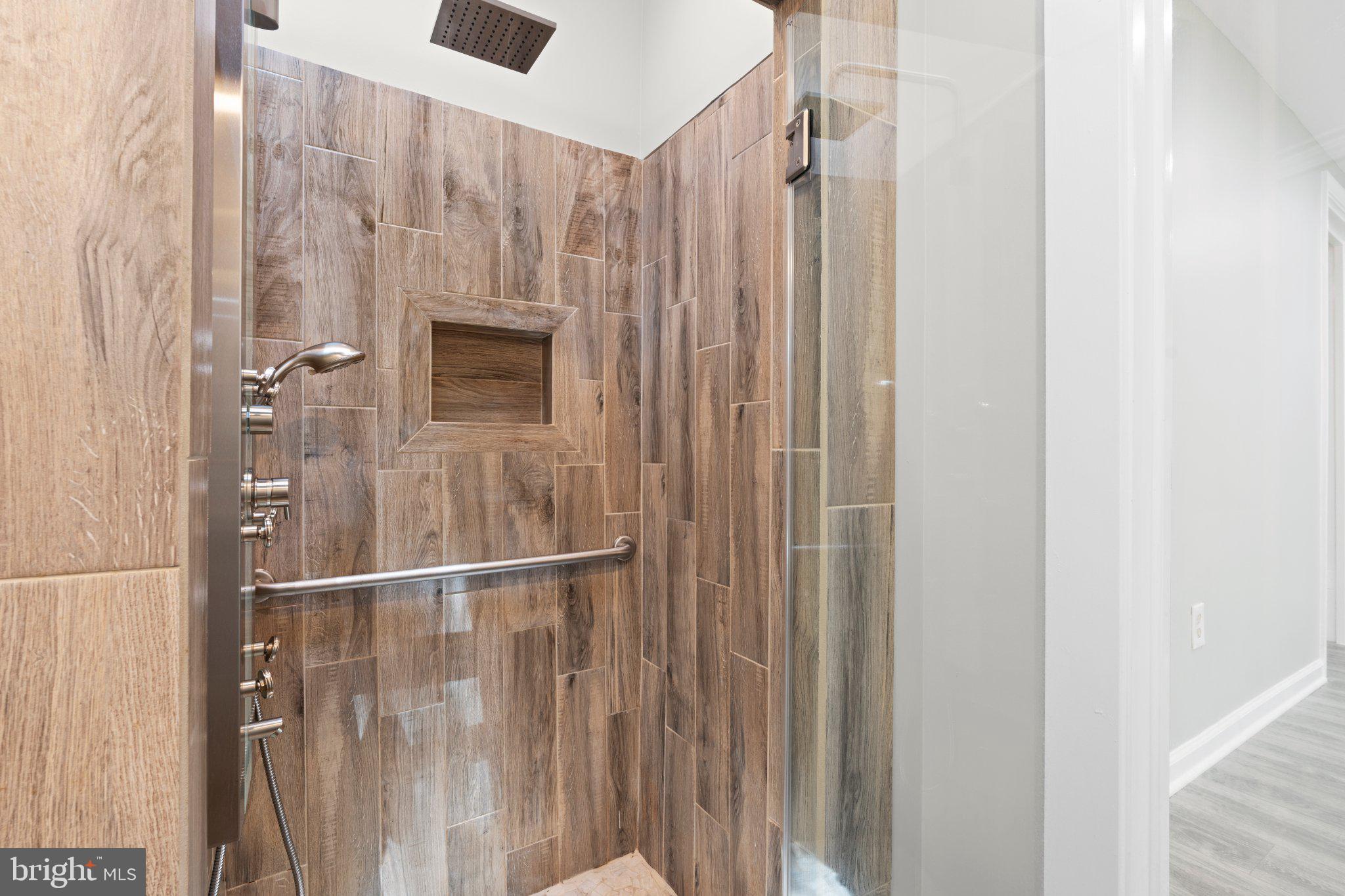 8405 Shirley Road Spotsylvania, VA 22551 - Photo 22 of 42 a bathroom with a shower and a shower curtain