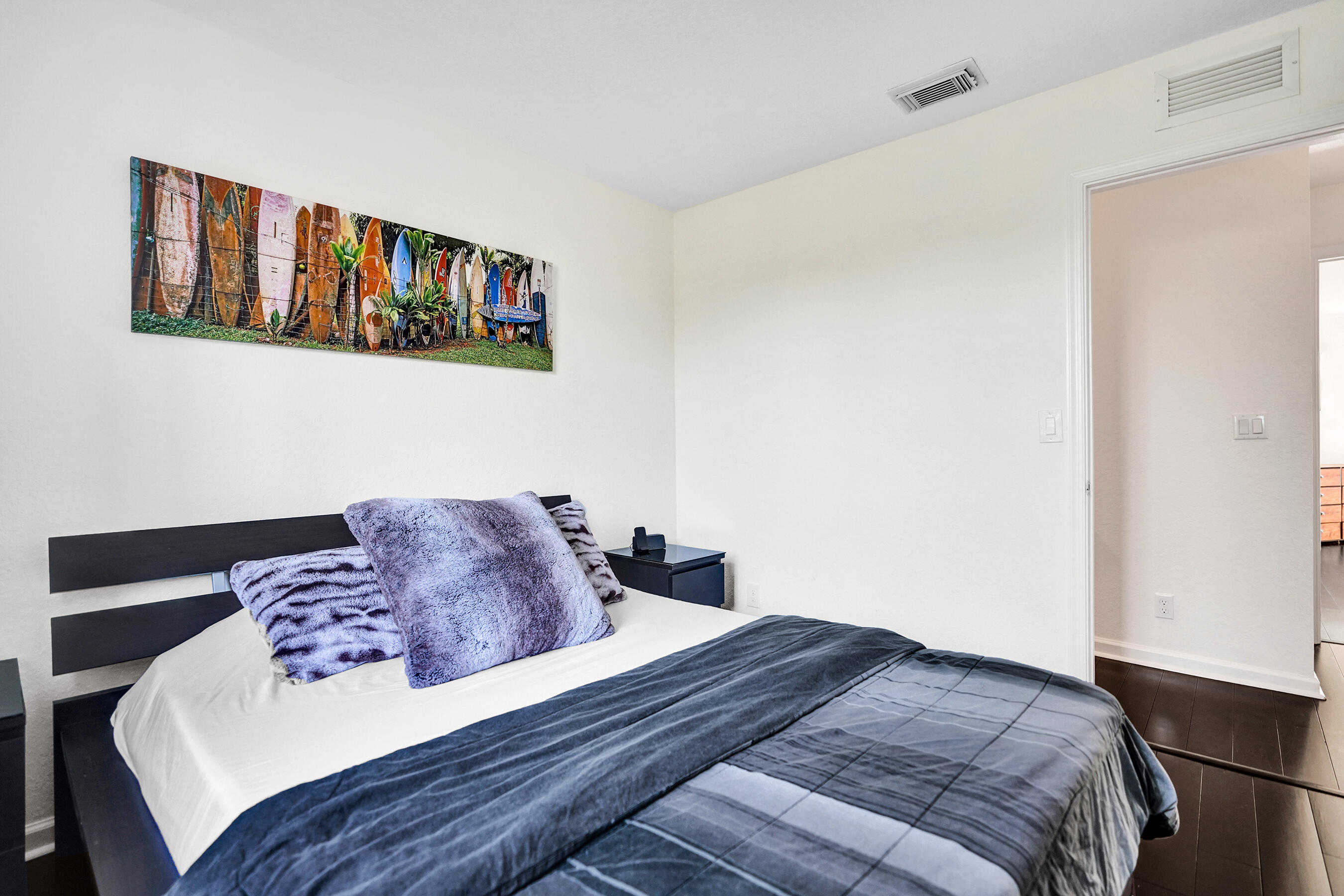 4533 Danson Way Delray Beach, FL 33445 - Photo 36 of 92 a bedroom with a bed and a wall painting