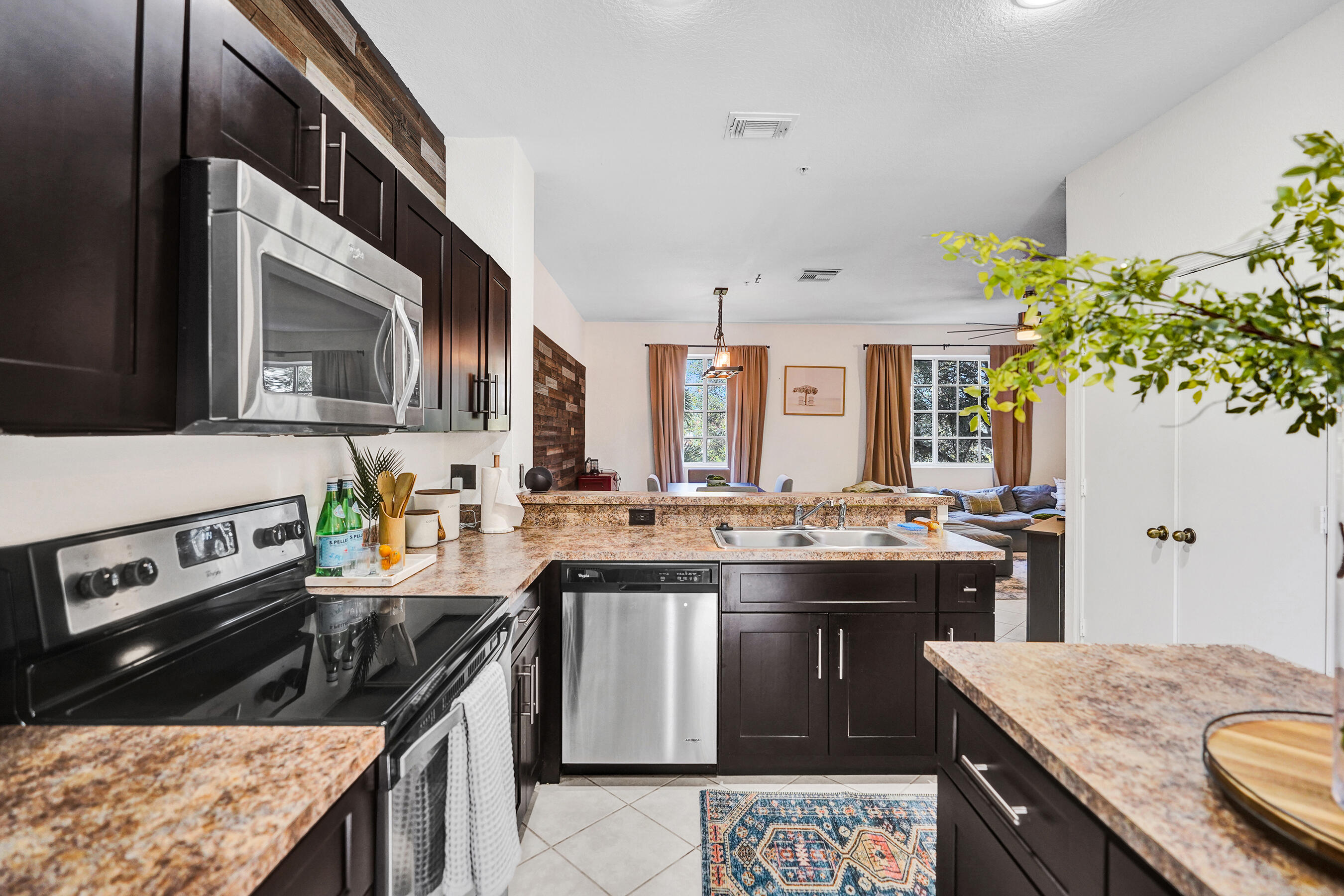 4533 Danson Way Delray Beach, FL 33445 - Photo 4 of 92 a kitchen with kitchen island granite countertop a sink stove and cabinets