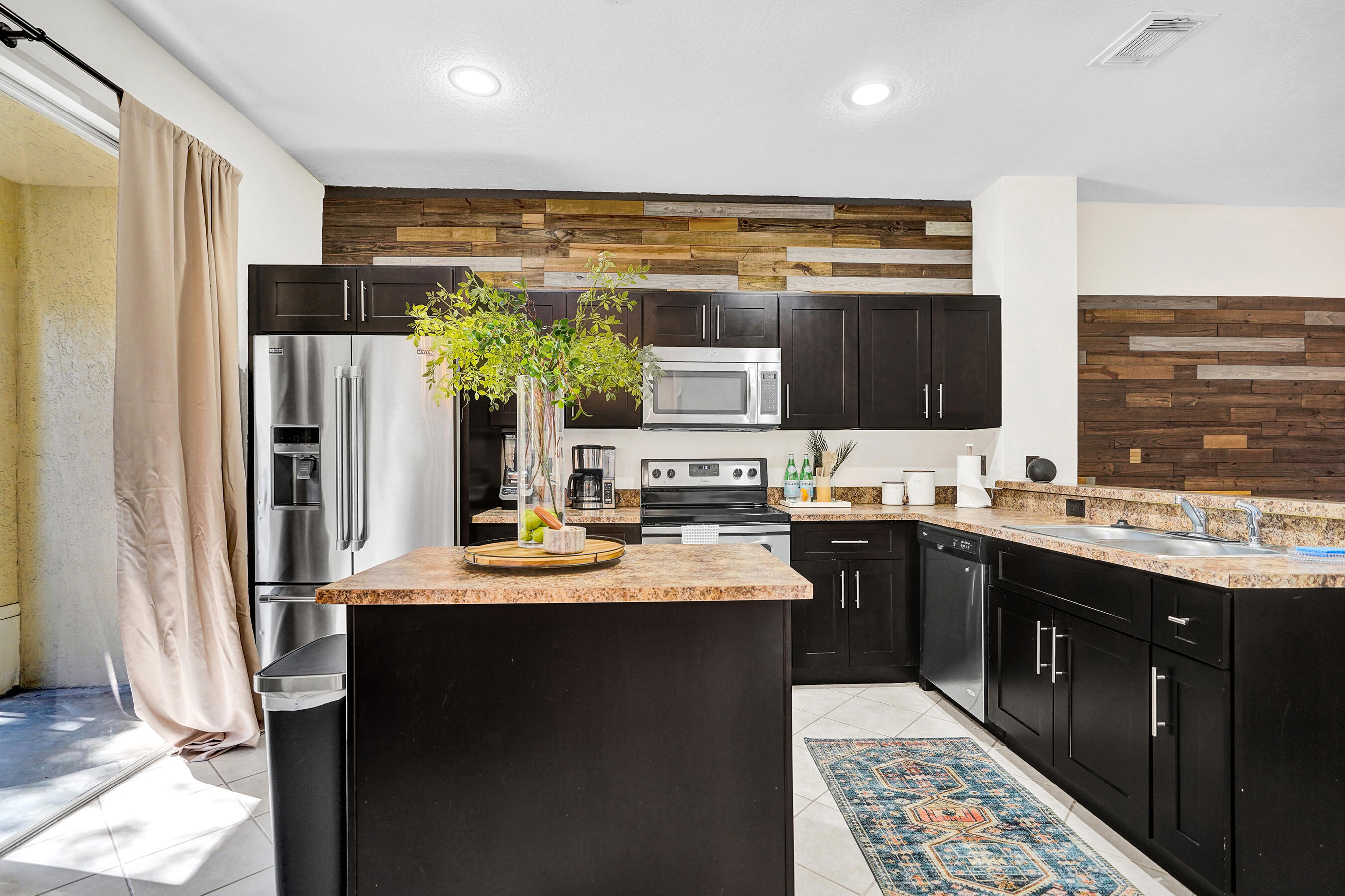 4533 Danson Way Delray Beach, FL 33445 - Photo 7 of 92 a kitchen with kitchen island granite countertop a sink stove and refrigerator