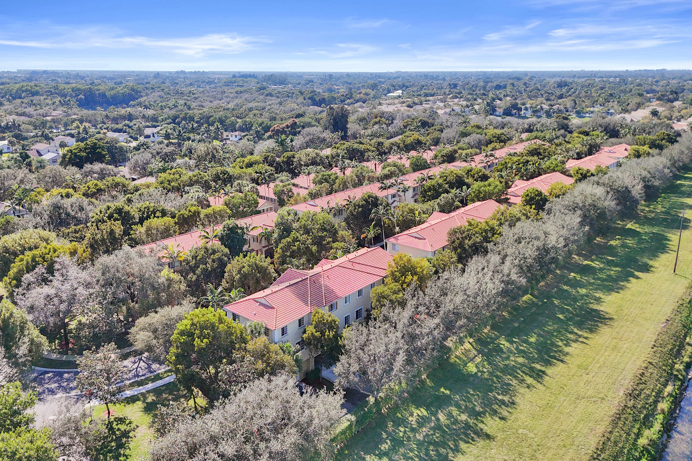 4533 Danson Way Delray Beach, FL 33445 - Photo 81 of 92 an aerial view of residential houses with outdoor space and trees
