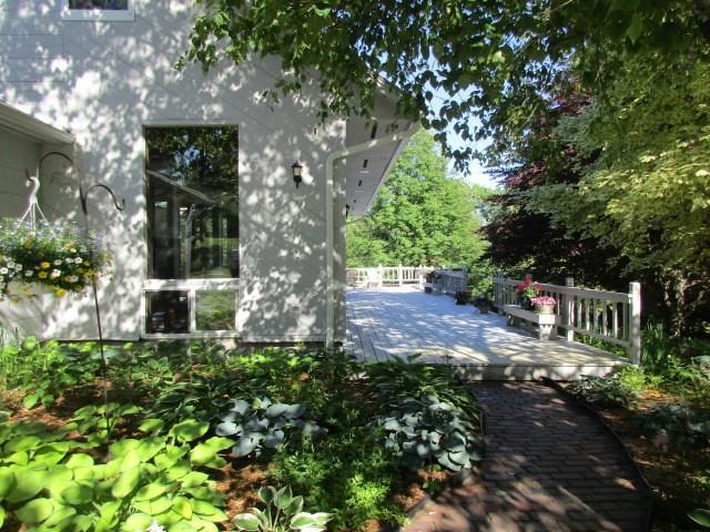 650 Neck Road South China, ME 04358 - Photo 22 of 36 Lovely landscaping leads to the deck.