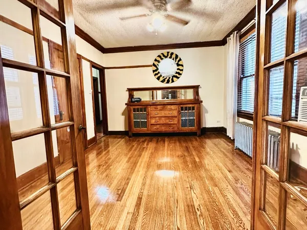 a kitchen with stainless steel appliances granite countertop a sink a stove a refrigerator wooden floor and cabinets