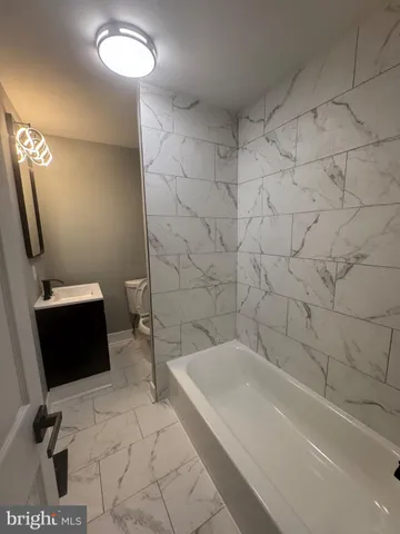 a bathroom with a sink a toilet and a bathtub