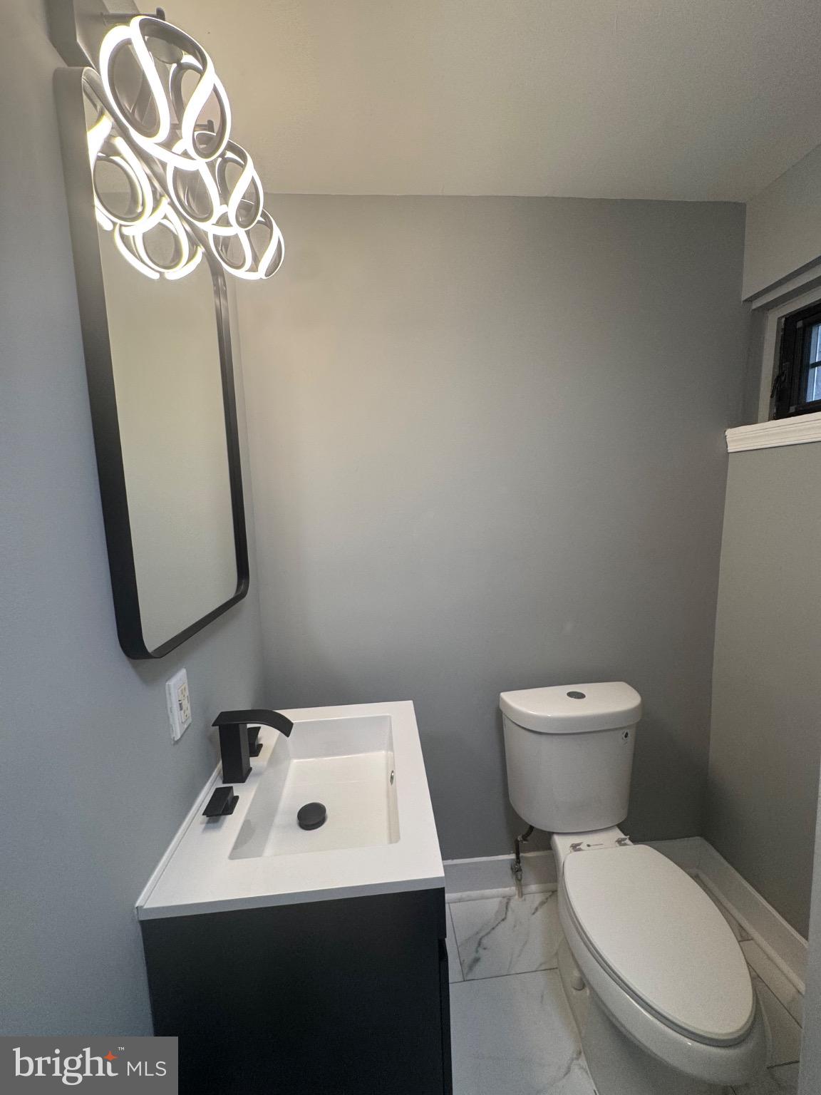 1717 North 26th Street, Unit 1 Philadelphia, PA 19121 - Photo 8 of 11 a white toilet sitting next to a bathroom sink