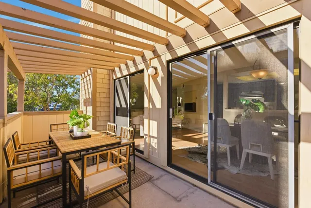 a dining room with glass top table and chairs