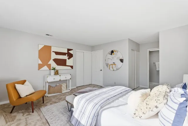 a bedroom with a bed and chair