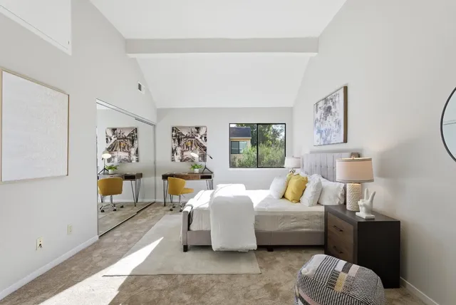 a bedroom with furniture and a lamp