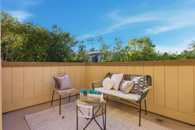 a roof deck with table and chairs