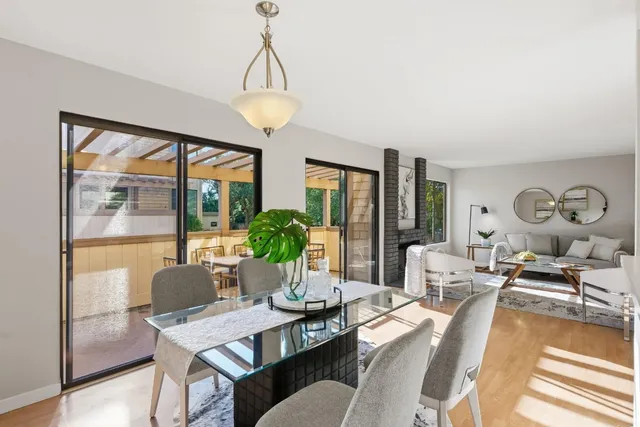 a living room with furniture a lamp a potted plant and a large window