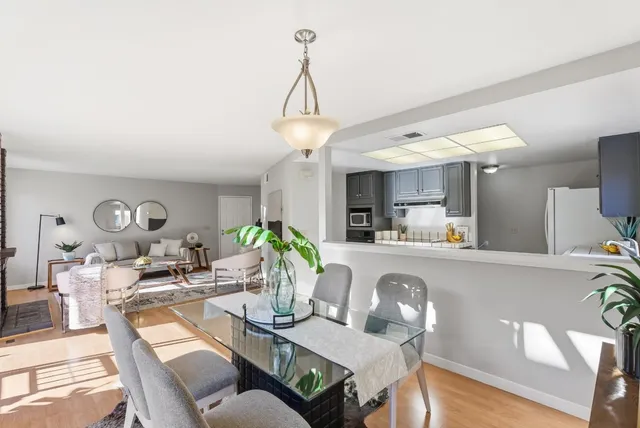 a view of a dining room with furniture and a chandelier