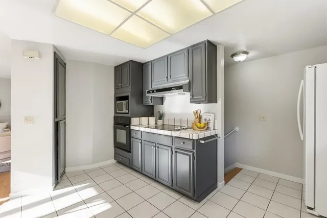 a kitchen with stainless steel appliances granite countertop a refrigerator and a sink