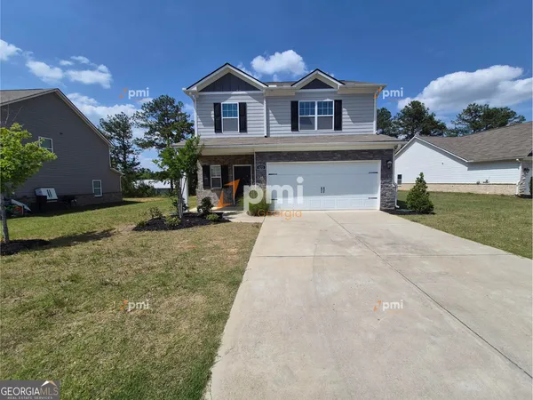 a front view of a house with a yard