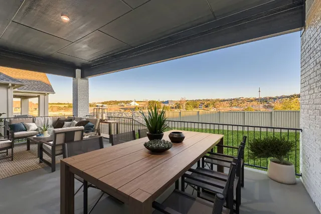 a view of a dining table and chairs on the roof deck
