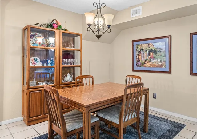 a view of a dining room with furniture and chandelier