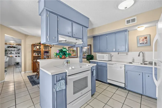 a kitchen with a sink cabinets and window