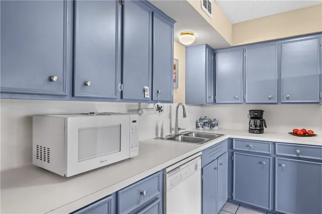 a kitchen with stainless steel appliances granite countertop white cabinets sink and granite counter tops