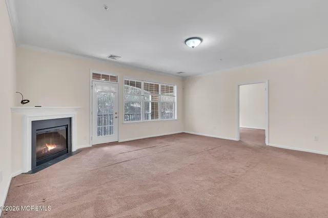 a view of empty room with a fireplace