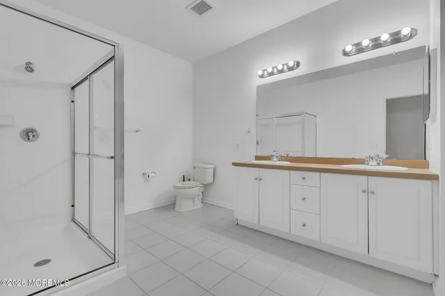 a spacious bathroom with a granite countertop sink mirror and toilet