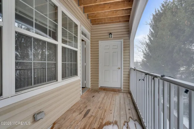 a view of wooden balcony with wooden floor