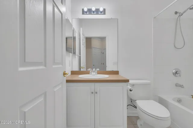 a bathroom with a granite countertop sink toilet a mirror and shower