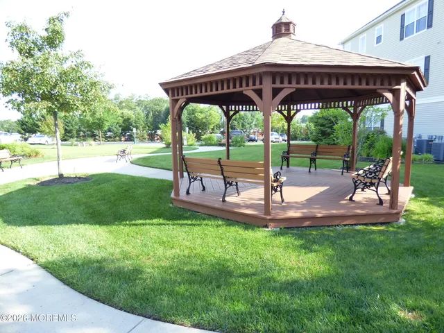a view of a deck with a table and chairs under an umbrella