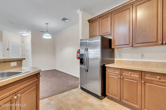 a kitchen with stainless steel appliances granite countertop a refrigerator and a sink