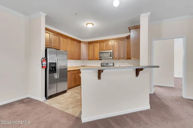 a kitchen with stainless steel appliances granite countertop a refrigerator a stove a sink and a refrigerator