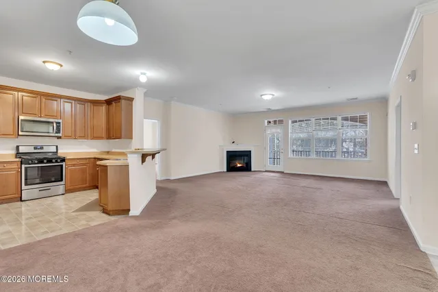 a view of a kitchen with a sink and dishwasher a refrigerator with wooden floor