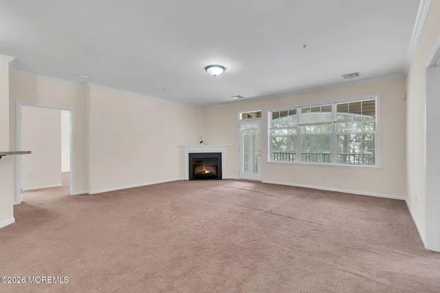 an empty room with furniture and a fireplace